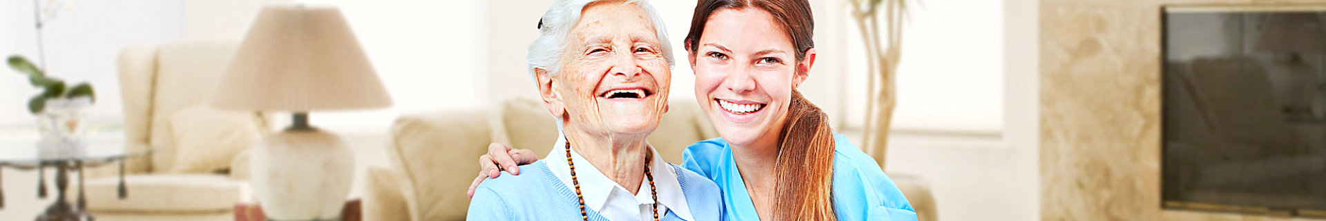 elderly woman and caregiver laughing
